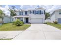 Charming two-story home with a well-manicured lawn, attached garage and neatly trimmed shrubbery at 36398 Spanish Rose Dr, Dade City, FL 33525