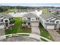 Beautiful home with a well-kept lawn, a paver driveway, and serene lake views at 38190 Shale Stone Ct, Zephyrhills, FL 33540