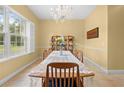 Charming dining area featuring a large table with a lace tablecloth and decorative display shelves at 4180 Jacaranda Cir, Brooksville, FL 34604