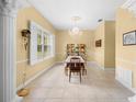Elegant dining room with a chandelier, decorative shelving, and large windows at 4180 Jacaranda Cir, Brooksville, FL 34604