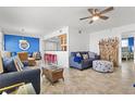 Comfortable living room with tile floors, coastal decor, and a cozy seating area featuring blue sofas at 445 Hamden Dr # 502, Clearwater Beach, FL 33767