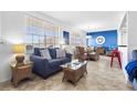 Bright living room featuring tile floors, contemporary furnishings, and an adjacent dining area at 445 Hamden Dr # 502, Clearwater Beach, FL 33767