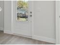 Bright entryway featuring hardwood floors, white door, and a view to the outdoors at 4717 W Mccoy St # 2, Tampa, FL 33616