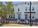 Charming townhouse with dark blue doors, black trim, and a decorative black fence at 4717 W Mccoy St # 2, Tampa, FL 33616