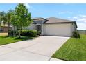 Beautiful single Gathering home featuring a two car garage, manicured lawn, and freshly painted exterior in a desirable neighborhood at 5208 Dandelion St, Apollo Beach, FL 33572