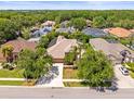 Expansive aerial view showcasing the home's location within a lush, green neighborhood at 5216 Kernwood Ct, Palm Harbor, FL 34685