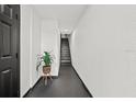 Bright entryway hallway with plant and staircase leading up at 616 Wheaton Trent Pl, Tampa, FL 33619