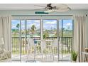 Relax on the balcony, furnished with stylish white seating, and enjoy breathtaking waterfront views and the sunset at 10355 Paradise Blvd # 413, Treasure Island, FL 33706