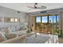 Light-filled living room with a balcony showcasing stunning water views at 10355 Paradise Blvd # 413, Treasure Island, FL 33706