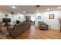Cozy living room with wood floors, ceiling fan, and comfortable seating arrangement at 11029 90Th Ave, Seminole, FL 33772
