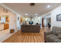 Spacious living room with wood floors, ceiling fan, open layout and neutral tones at 11029 90Th Ave, Seminole, FL 33772