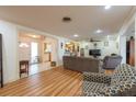 Inviting living room with wood floors, ceiling fan, open layout and neutral tones at 11029 90Th Ave, Seminole, FL 33772