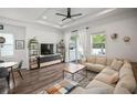 Bright living room features modern décor, hardwood floors, recessed lights, and access to the outdoor deck at 11227 Moultrie Pl, Tampa, FL 33625