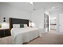 Spacious main bedroom with a king bed, accent lighting, Roman Numeral art, and an ensuite bathroom at 11227 Moultrie Pl, Tampa, FL 33625