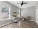 Cozy bedroom with hardwood floors, large windows, and a ceiling fan at 116 W Stanley St, Tampa, FL 33604