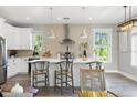 Gorgeous open kitchen featuring stainless steel appliances, a center island, and modern pendant lighting at 116 W Stanley St, Tampa, FL 33604