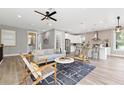 Bright and airy living room open to kitchen, featuring modern decor, light hardwood floors and stylish furnishings at 116 W Stanley St, Tampa, FL 33604
