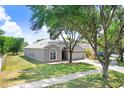 Beautiful single-Gathering home showcasing a lush green lawn and convenient two-car garage at 1177 Emerald Hill Way, Valrico, FL 33594