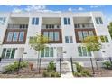 Modern townhome featuring a private front entrance, black metal fence, and minimalist landscaping at 121 E Warren Ave # 1, Tampa, FL 33602