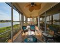 Relaxing screened-in patio with comfortable seating and stunning lake views at 1348 Emerald Dunes Dr, Sun City Center, FL 33573