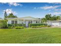 Charming single-story home with lush green lawn, manicured hedges, and a well-maintained front yard at 1404 84Th N Ave, St Petersburg, FL 33702