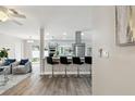 Modern open-concept kitchen with sleek countertops, stainless steel appliances, and bar stool seating at 1812 Teakwood Ln, Dunedin, FL 34698