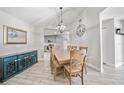 Dining room with modern lighting, elegant decor, and views into kitchen at 18408 Hanna Rd, Lutz, FL 33549