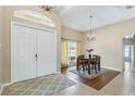 Inviting dining area with natural light, wood floors, a chandelier, and a view of the front entry at 20254 Ravens End Dr, Tampa, FL 33647