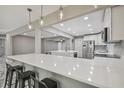 Open concept kitchen with large island, stainless steel appliances, and modern lighting at 2042 Craft Ln, Sarasota, FL 34239