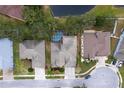 Aerial view showing the home with a screened-in pool, nestled amongst trees, and a quiet neighborhood at 21215 Tyrell Way, Land O Lakes, FL 34638