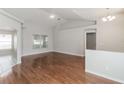 Bright and open living room featuring hardwood floors, high ceilings, and lots of natural light at 2203 Malaga Ave, Spring Hill, FL 34609