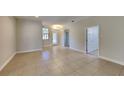 Spacious living room with tile flooring, neutral walls, a chandelier, and a doorway to other rooms at 2416 Caraway Dr, Venice, FL 34292