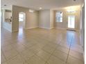 Bright, open-concept living room with neutral paint, tile flooring, and natural light at 2416 Caraway Dr, Venice, FL 34292