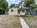 Charming single-story home with a walkway leading to the front door and windows on either side at 2435 37Th N Ave, St Petersburg, FL 33713
