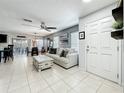 Comfortable living space with tile floors and a view into the kitchen and dining area at 2530 Sandy Beach Ln, Clearwater, FL 33763