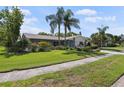 Well-maintained home with lush lawn and mature trees adding to the curb appeal at 2810 Doone Cir, Palm Harbor, FL 34684