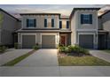Inviting townhome with a two-car garage, quaint landscaping, and a warm, welcoming entrance at 31970 Blue Passing Loop, Wesley Chapel, FL 33545
