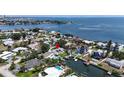 Aerial view of waterfront neighborhood featuring homes with pools and boat docks, offering coastal living at 3436 Manatee Se Dr, St Petersburg, FL 33705