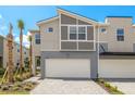 Modern two-story townhome featuring a two-car garage and contemporary design at 3472 Timber Crossing Ave, Brandon, FL 33511