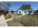 Charming blue house with a picket fence and 'Coming Soon' sign, showcasing a delightful curb appeal at 3501 7Th N Ave, St Petersburg, FL 33713