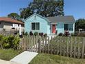 Inviting blue house with neat landscaping and a classic white picket fence, creating a warm curb appeal at 3501 7Th N Ave, St Petersburg, FL 33713