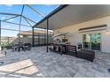 The screened patio offers an inviting dining area and comfortable lounge at 35780 Sunflower Hill Dr, Zephyrhills, FL 33541
