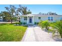 Beautiful single-story house featuring a well-maintained lawn, nicely landscaped entrance, and a freshly painted facade at 5030 9Th S Ave, Gulfport, FL 33707