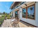Inviting outdoor patio with stylish seating, perfect for enjoying the beautiful scenery and natural light at 5659-5657 Shore S Blvd, Gulfport, FL 33707