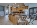 Lovely kitchen features granite countertops, stainless steel appliances, breakfast bar, and custom wood cabinetry at 620 Bayway Blvd # 1, Clearwater, FL 33767