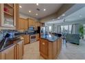 Beautiful kitchen features granite countertops, stainless steel appliances, breakfast bar, and open layout to the living area at 620 Bayway Blvd # 1, Clearwater, FL 33767