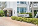 The entrance to the Harbour Hill condo complex features meticulous landscaping with brick pavers and elegant signage at 700 Beach Ne Dr # 803, St Petersburg, FL 33701