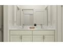 Bright bathroom with a double sink vanity featuring marble countertops and modern fixtures at 7525 E 116Th St, Palmetto, FL 34221