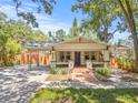 Charming home with brick walkway, inviting porch, and convenient carport at 906 E Broad St, Tampa, FL 33604