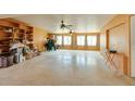 Expansive living room with built-in shelving, ceiling fans, and plenty of space for storage at 9469 Treasure Ne Ln, St Petersburg, FL 33702